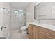 Bathroom with a stylish sliding glass shower, vanity with wood cabinets, and modern fixtures at 2622 Murdock, Marietta, GA 30062
