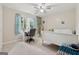 Cozy bedroom with natural light, a white bed frame, a desk, and blue accents in the curtains at 2622 Murdock, Marietta, GA 30062