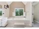 Bright bathroom with a soaking tub, tiled floors and a large window with shutters at 2622 Murdock, Marietta, GA 30062
