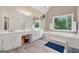 Bright bathroom with dual vanity sinks, tiled floors, large window and a soaking tub at 2622 Murdock, Marietta, GA 30062
