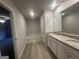 Bright bathroom with white cabinets, granite countertops, soaking tub, and modern fixtures at 11045 Shadow Creek Ter # 65, Hampton, GA 30228