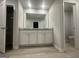 Modern bathroom featuring a double vanity, granite countertops and neutral walls at 11045 Shadow Creek Ter # 65, Hampton, GA 30228