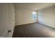 Neutral bedroom with a window bringing in natural light and soft carpet at 11045 Shadow Creek Ter # 65, Hampton, GA 30228