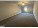 Spacious carpeted bedroom with ceiling fan, window and natural light at 11045 Shadow Creek Ter # 65, Hampton, GA 30228
