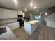 Modern kitchen with island, granite countertops, stainless steel appliances, and ample storage at 11045 Shadow Creek Ter # 65, Hampton, GA 30228