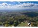 Picturesque aerial view of lush, tree-covered landscape with barn and country home at 335 Gum Creek Rd, Roopville, GA 30170