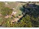 Aerial view showing approximate property lines of a sprawling farm with barn and sheds at 335 Gum Creek Rd, Roopville, GA 30170