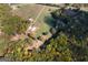 Aerial view of a sprawling farm with a barn, sheds and verdant pastures at 335 Gum Creek Rd, Roopville, GA 30170