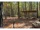 Backyard view of a wooden cage surrounded by falling leaves at 335 Gum Creek Rd, Roopville, GA 30170