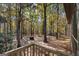 Backyard featuring mature trees, a fire pit, and a house with a screened-in porch at 335 Gum Creek Rd, Roopville, GA 30170