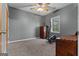 Gray bedroom with carpet, a window providing natural light, and a ceiling fan at 335 Gum Creek Rd, Roopville, GA 30170