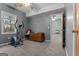 A gray bedroom featuring neutral carpet, an open doorway, and a bright window at 335 Gum Creek Rd, Roopville, GA 30170
