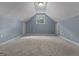 Carpeted bonus room featuring ample natural light and a neutral color scheme at 335 Gum Creek Rd, Roopville, GA 30170