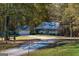 Exterior view of a charming home with a detached garage with fall foliage at 335 Gum Creek Rd, Roopville, GA 30170