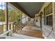Inviting covered porch features a swing and ample space for enjoying the outdoors at 335 Gum Creek Rd, Roopville, GA 30170