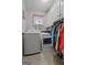Well-lit laundry room with washer, dryer, and ample storage cabinets at 335 Gum Creek Rd, Roopville, GA 30170