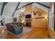 Cozy living room with vaulted ceiling, stone fireplace, and abundant natural light at 335 Gum Creek Rd, Roopville, GA 30170