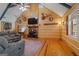 Inviting living room featuring a stone fireplace, wood floors, and rustic decor at 335 Gum Creek Rd, Roopville, GA 30170