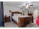 Cozy main bedroom featuring a wooden bed, ceiling fan and ensuite access at 335 Gum Creek Rd, Roopville, GA 30170