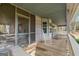 Covered front porch with rocking chairs, screened in portion and wooden floors at 335 Gum Creek Rd, Roopville, GA 30170