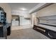 Spacious room featuring carpeted and tiled areas, along with a tanning bed and white cabinets at 335 Gum Creek Rd, Roopville, GA 30170
