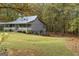 Exterior view of the home featuring a lush green lawn at 335 Gum Creek Rd, Roopville, GA 30170