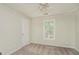 Clean bedroom with neutral carpet and a bright window, ample space for a bed at 5523 Forest Dr, Loganville, GA 30052