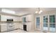 Well-lit kitchen featuring white cabinets, stainless steel appliances, and tile floors at 5523 Forest Dr, Loganville, GA 30052