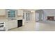 Bright kitchen flows into the living room with fireplace and large windows at 5523 Forest Dr, Loganville, GA 30052