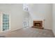 Bright living room with a brick fireplace, large windows, and neutral carpeting at 5523 Forest Dr, Loganville, GA 30052