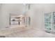Open-concept living room showing kitchen with white cabinets, and large windows at 5523 Forest Dr, Loganville, GA 30052