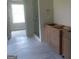 Bathroom features walk-in shower with glass door and wooden cabinets, offering a blend of modern and natural elements at 49 Durham Estates Dr, Sharpsburg, GA 30277