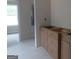 Bathroom with unfinished cabinets and view of possible shower with exposed plumbing at 49 Durham Estates Dr, Sharpsburg, GA 30277