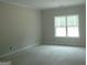 Clean and bright bedroom with large window, perfect for relaxation and comfort at 49 Durham Estates Dr, Sharpsburg, GA 30277