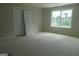 Bedroom with large window and view of backyard at 49 Durham Estates Dr, Sharpsburg, GA 30277
