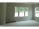A bright bedroom is seen with multiple windows and light colored walls at 49 Durham Estates Dr, Sharpsburg, GA 30277