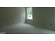 Bright bedroom featuring a window with natural light and neutral walls at 49 Durham Estates Dr, Sharpsburg, GA 30277