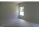Bright bedroom with natural light from a window showing the surrounding trees at 49 Durham Estates Dr, Sharpsburg, GA 30277