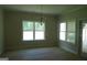 Dining room with large windows offering plentiful natural light, complimented by a stylish chandelier, enhancing the dining space at 49 Durham Estates Dr, Sharpsburg, GA 30277