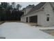 Spacious home with light-colored stone exterior and concrete driveway at 49 Durham Estates Dr, Sharpsburg, GA 30277