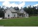 Beautiful single-story home featuring a well-manicured lawn, stone accents, and a welcoming front porch at 49 Durham Estates Dr, Sharpsburg, GA 30277