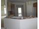 Kitchen island with sink and unfinished cabinetry and adjacent rooms at 49 Durham Estates Dr, Sharpsburg, GA 30277