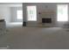 Cozy living room with stone fireplace and large windows for natural light at 49 Durham Estates Dr, Sharpsburg, GA 30277