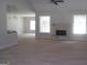 Spacious living room with stone fireplace, two windows, and open floor plan at 49 Durham Estates Dr, Sharpsburg, GA 30277