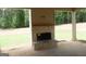 Covered back porch with a beautiful stone fireplace, perfect for outdoor entertaining at 49 Durham Estates Dr, Sharpsburg, GA 30277