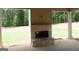 Covered back porch with a beautiful stone fireplace, perfect for outdoor entertaining at 49 Durham Estates Dr, Sharpsburg, GA 30277