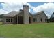 Expansive backyard featuring a covered porch area and well-maintained lawn at 49 Durham Estates Dr, Sharpsburg, GA 30277