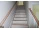 Staircase with wooden handrail and white painted stairs at 49 Durham Estates Dr, Sharpsburg, GA 30277