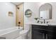 Modern bathroom with tiled shower and tub, black vanity, and neutral decor at 2541 Peyton Woods Sw Trl, Atlanta, GA 30311