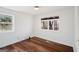 Well-lit bedroom features wood floors, neutral colors, and large windows overlooking trees at 2541 Peyton Woods Sw Trl, Atlanta, GA 30311
